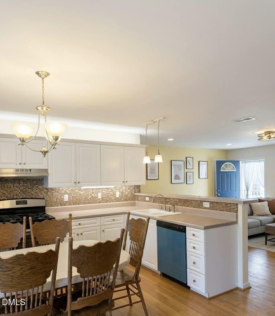 609 Shambley Road Mebane, NC 27302 - Photo 4 of 17 a kitchen with stainless steel appliances granite countertop a stove and a sink