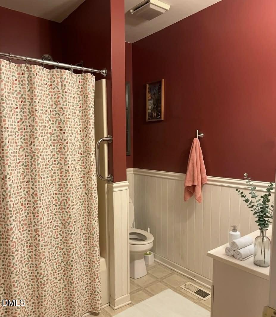 609 Shambley Road Mebane, NC 27302 - Photo 7 of 17 a bathroom with a shower curtain and a sink