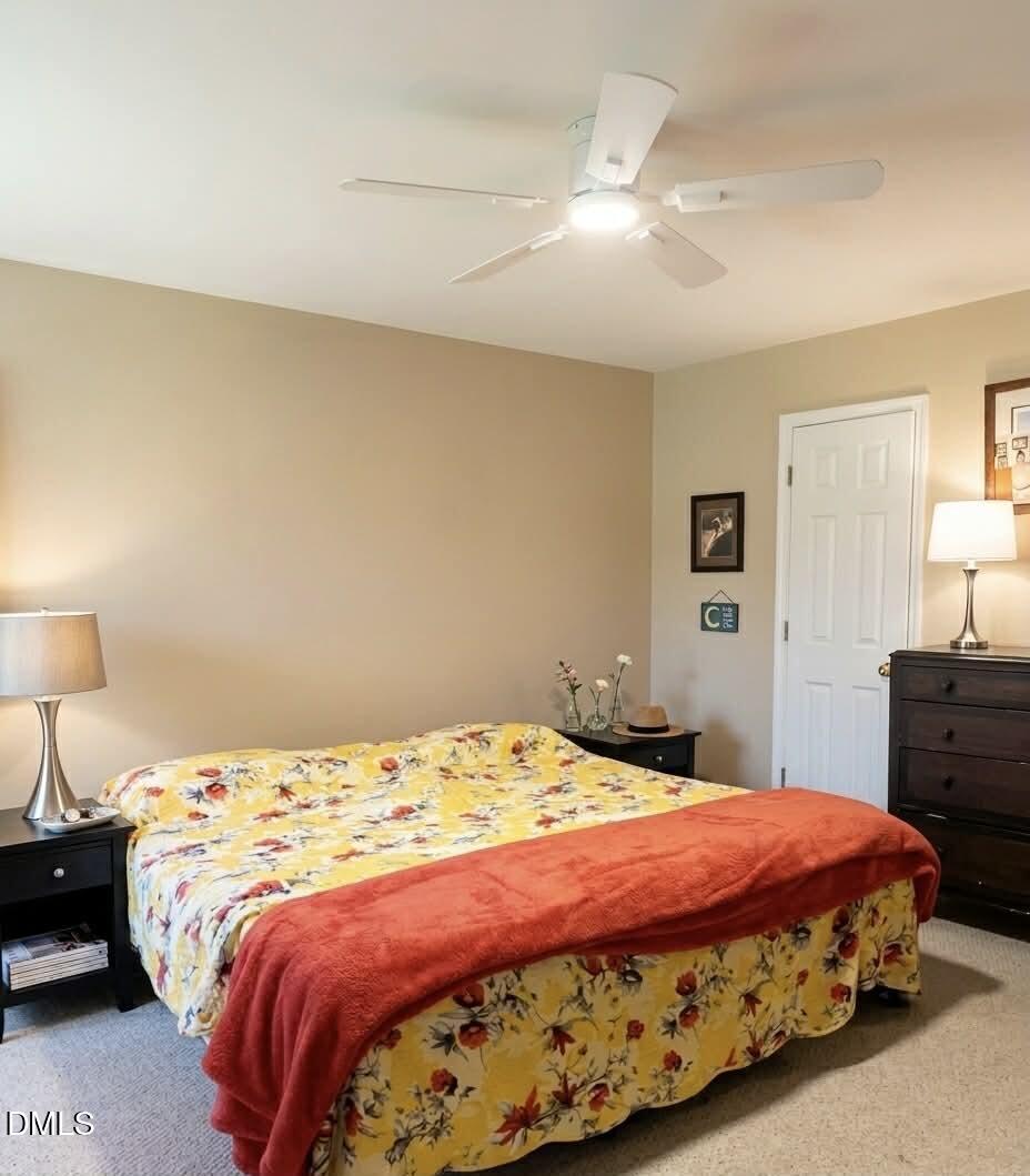 609 Shambley Road Mebane, NC 27302 - Photo 10 of 17 a bedroom with a bed and a lamp on dresser