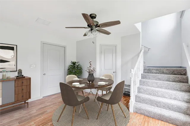 a dining room with furniture and wooden floor
