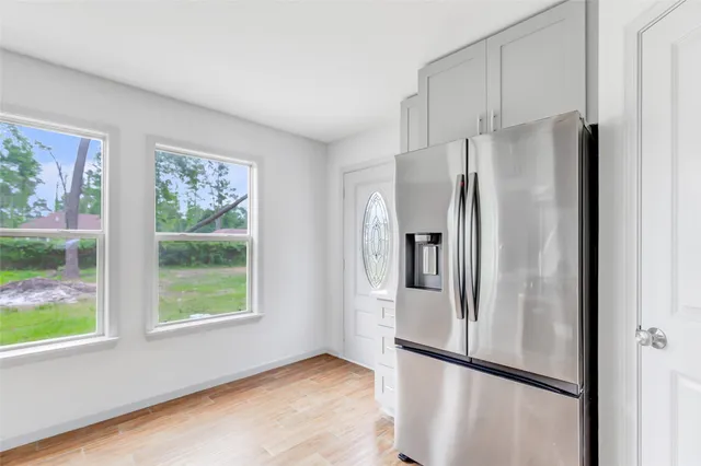 a metallic refrigerator freezer sitting in a kitchen