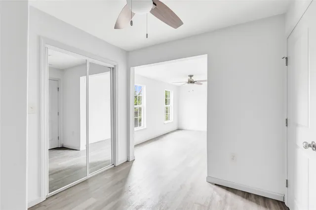 a view of a hallway with wooden floor
