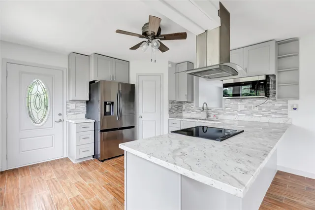 a kitchen with refrigerator cabinets and a sink
