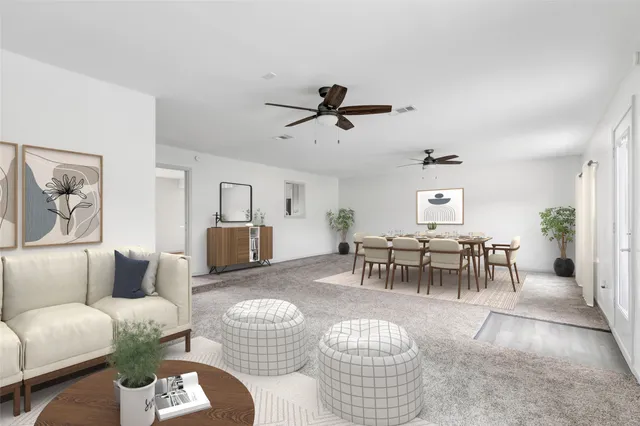 a living room with furniture a chandelier and a dining table