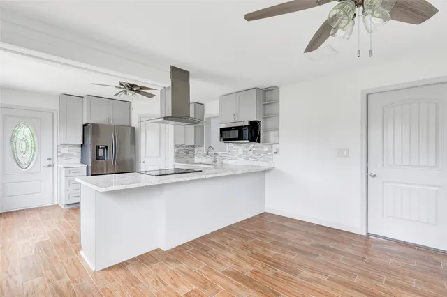 a kitchen with stainless steel appliances a sink and a refrigerator