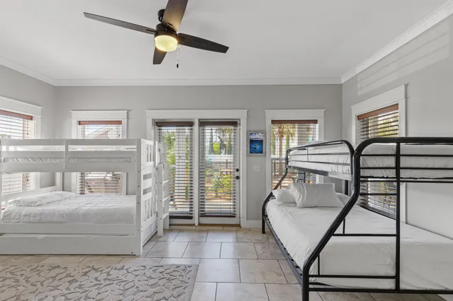 a living room with furniture and a ceiling fan