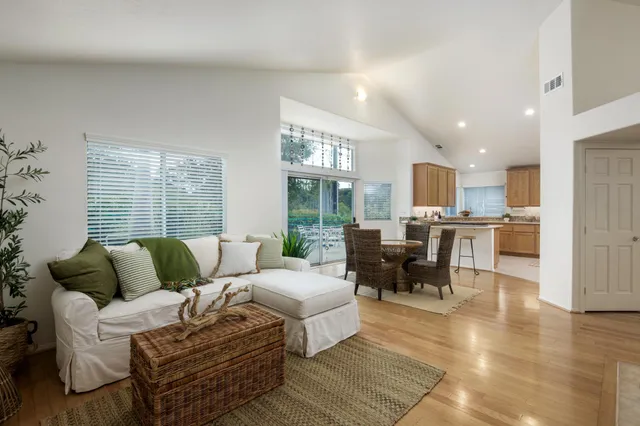 a living room with furniture and large windows