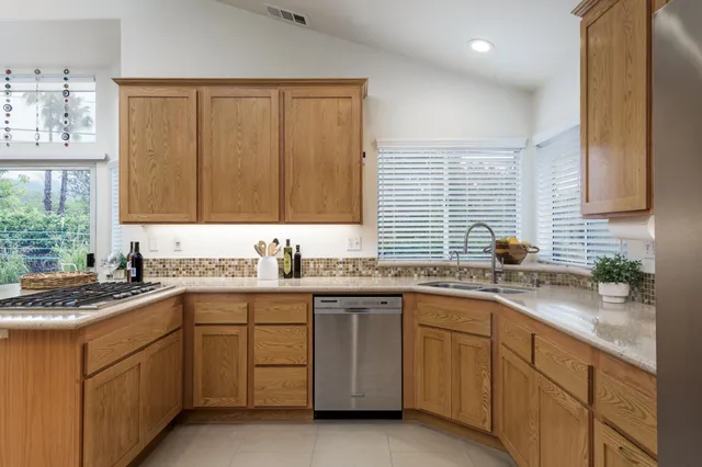 a kitchen with a sink stove and window