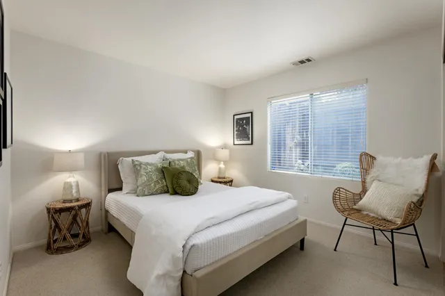 a bedroom with a bed and a chair