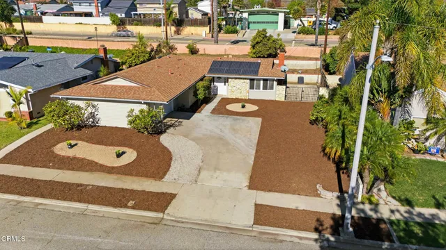 an aerial view of a house with a swimming pool and outdoor space