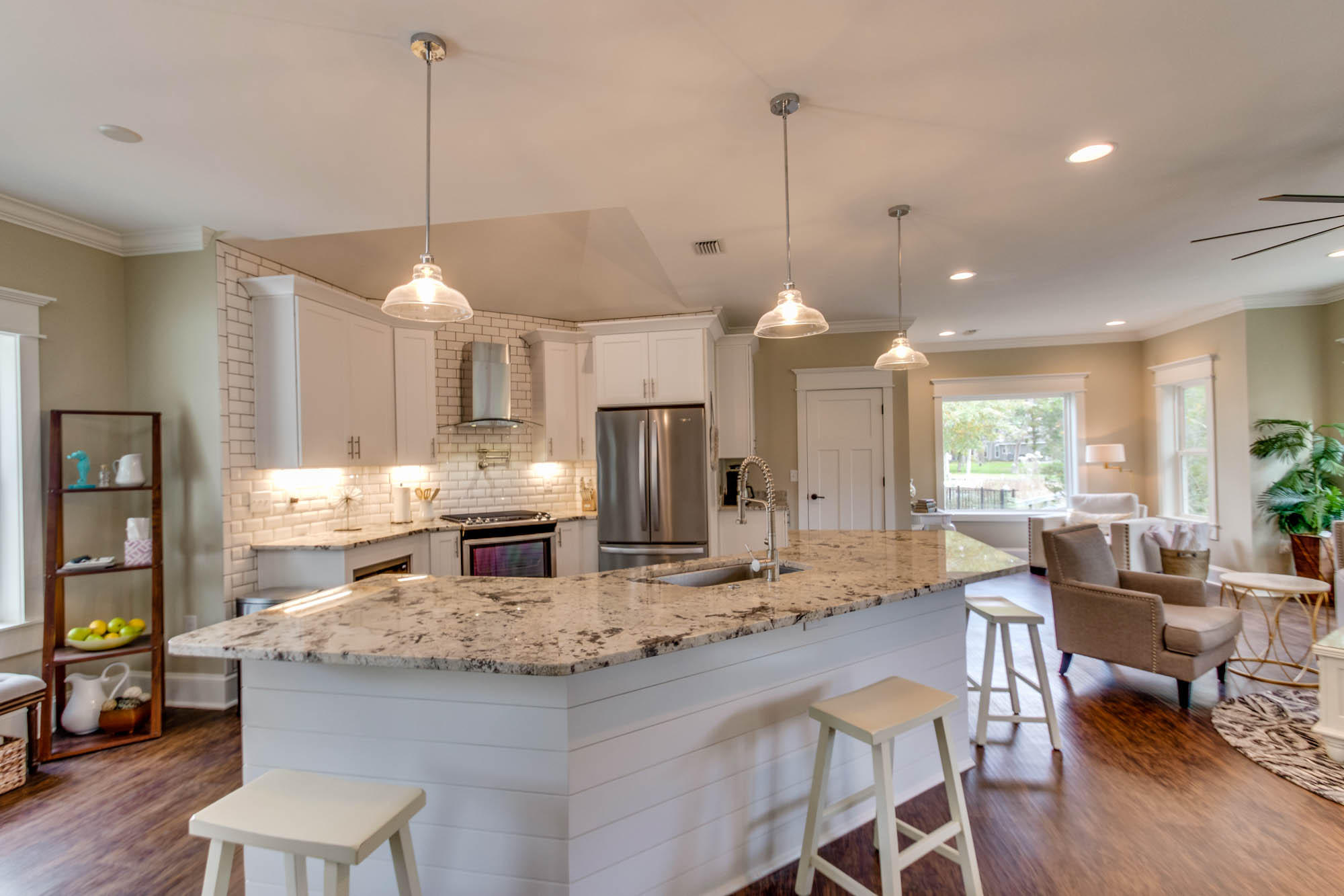 148 Rearden Way Santa Rosa Beach, FL 32459 - Photo 11 of 43 a kitchen with stainless steel appliances kitchen island granite countertop a table chairs and a refrigerator