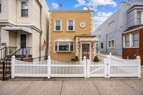 a front view of a house with a fence