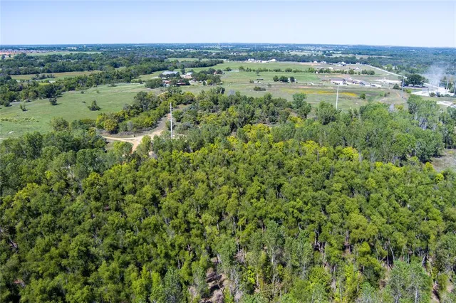 an aerial view of a houses with a yard