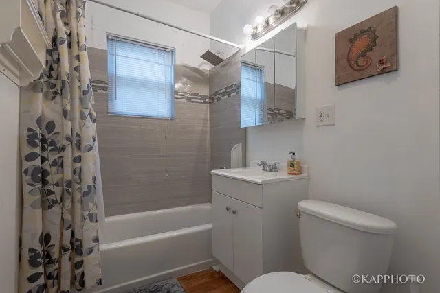 a bathroom with a toilet a sink and bathtub