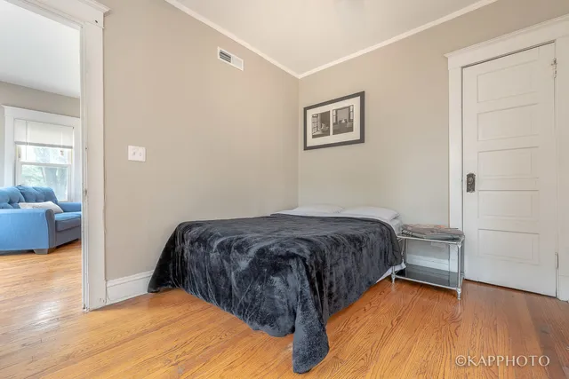a bedroom with a bed and a view of livingroom