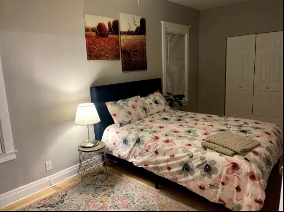 a bedroom with a bed and mirror