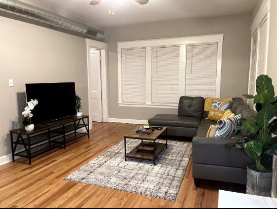 217 Des Plaines Avenue, Unit 1 Forest Park, IL 60130 - Photo 3 of 15 a living room with furniture and a flat screen tv