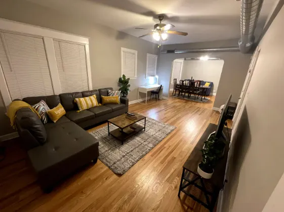 a living room with furniture and wooden floor