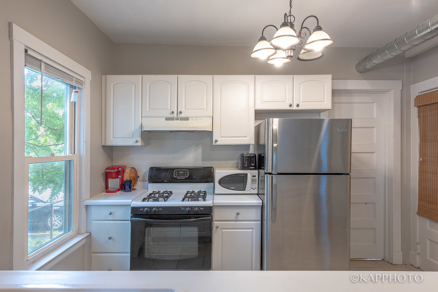 217 Des Plaines Avenue, Unit 1 Forest Park, IL 60130 - Photo 8 of 15 a kitchen with a refrigerator a stove a sink and dishwasher with kitchen countertops