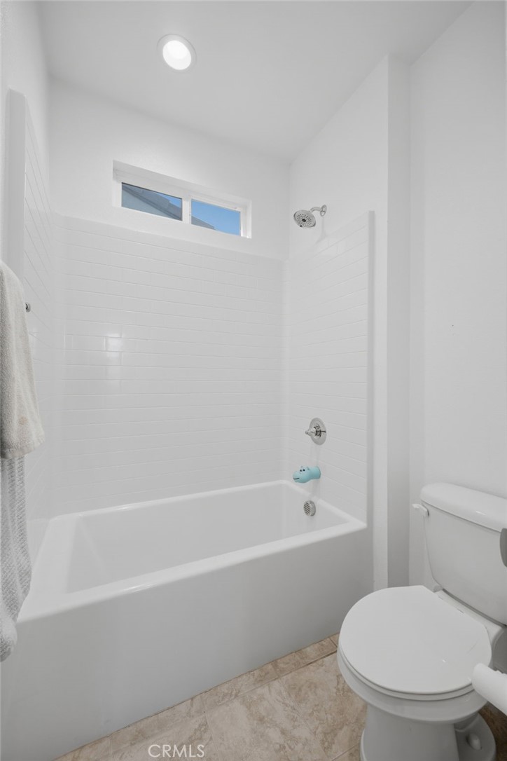 32736 Brunello Way Temecula, CA 92591 - Photo 15 of 75 a white toilet and tub sitting next to a bathroom sink