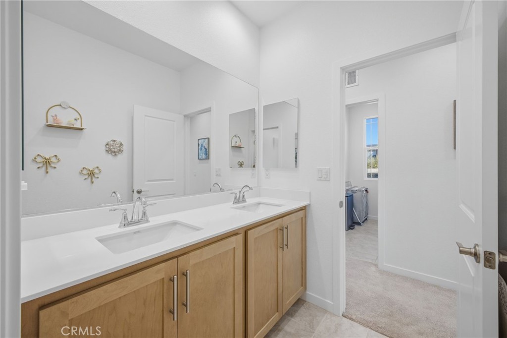 32736 Brunello Way Temecula, CA 92591 - Photo 16 of 75 a bathroom with a sink and a mirror