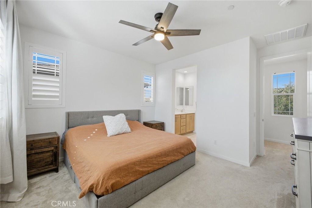 32736 Brunello Way Temecula, CA 92591 - Photo 25 of 75 a bedroom with a bed and a ceiling fan