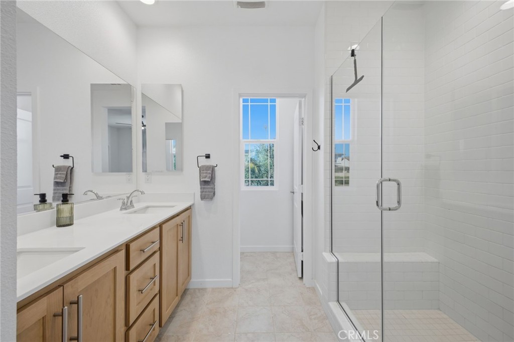 32736 Brunello Way Temecula, CA 92591 - Photo 30 of 75 a bathroom with a double vanity sink and mirror