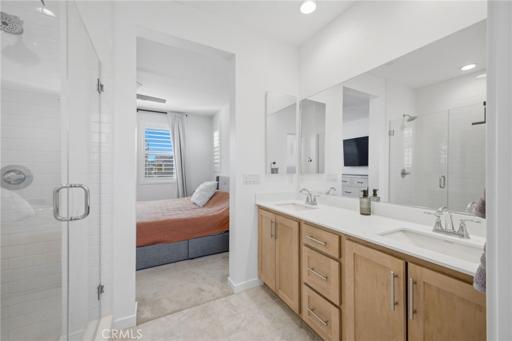 32736 Brunello Way Temecula, CA 92591 - Photo 31 of 75 a spacious bathroom with a double vanity sink a large mirror and shower
