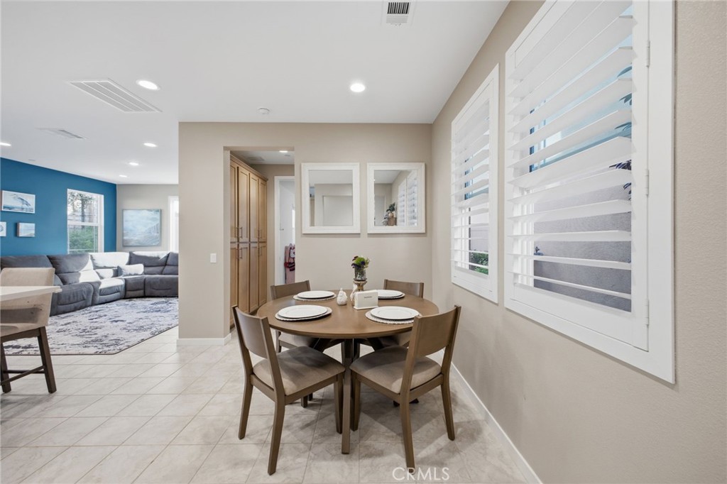 32736 Brunello Way Temecula, CA 92591 - Photo 35 of 75 a view of a dining room with furniture and a potted plant
