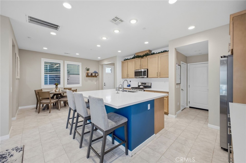 32736 Brunello Way Temecula, CA 92591 - Photo 43 of 75 a kitchen with stainless steel appliances kitchen island granite countertop a sink and cabinets