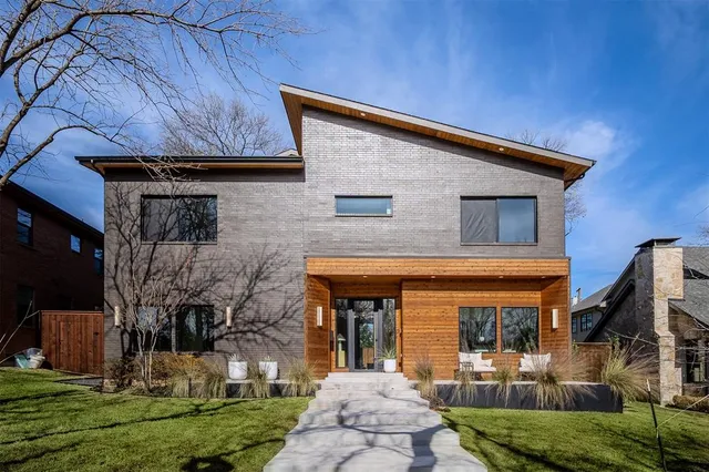a front view of house with a garden