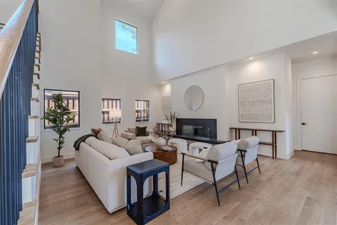 a living room with furniture a fireplace and a window