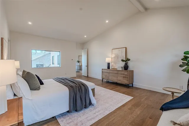 a bedroom with a bed and wooden floor