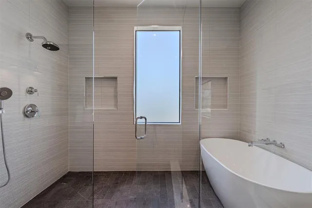 a bathroom with a bathtub and shower