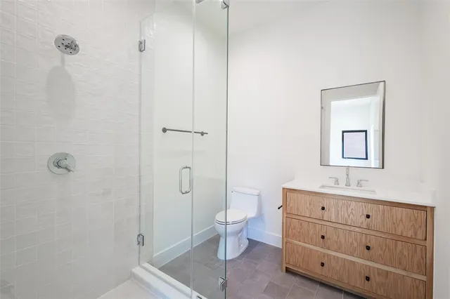 a bathroom with a shower a sink and toilet