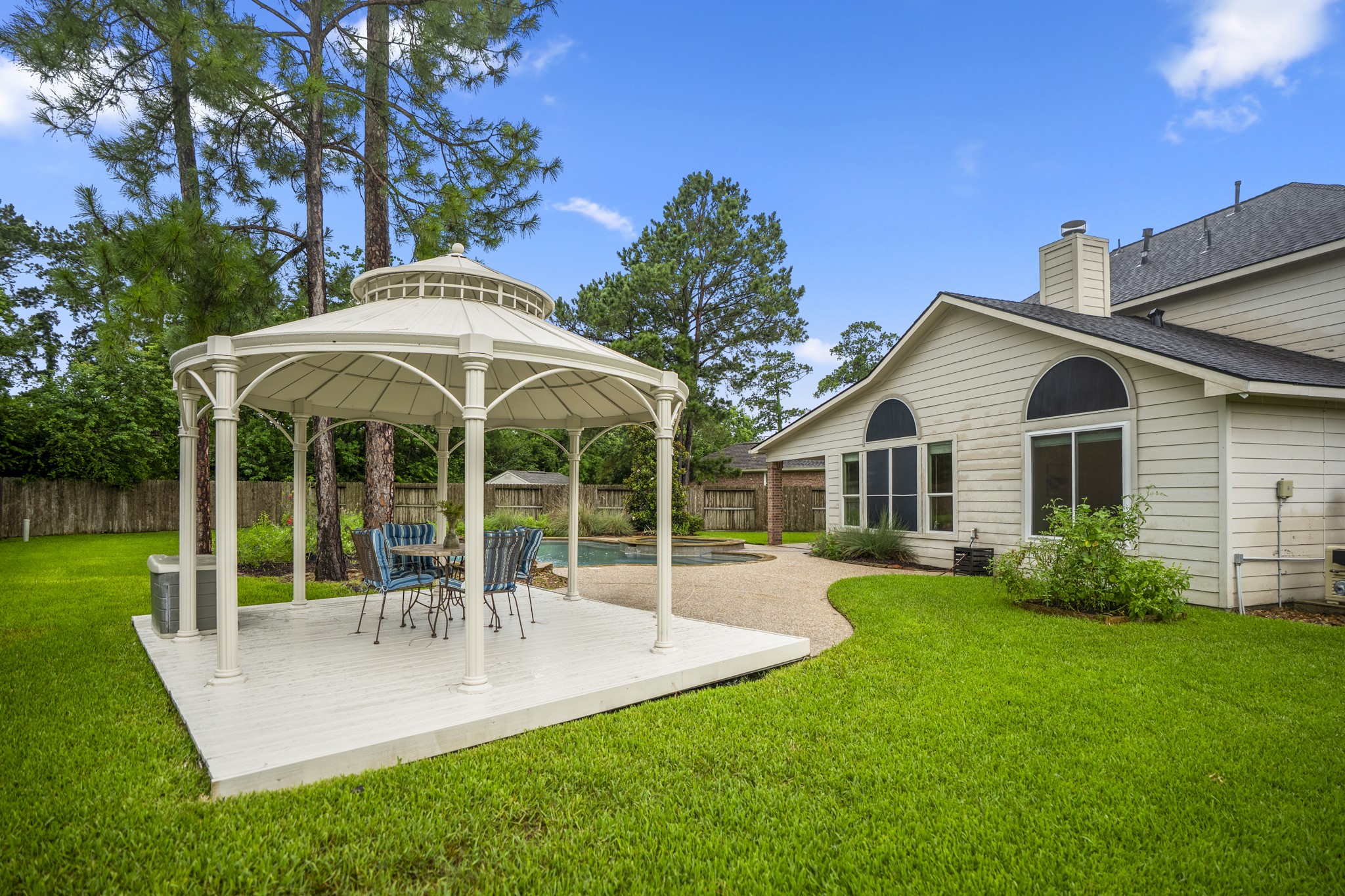 6311 Sparrows Glen Lane Spring, TX 77379 - Photo 35 of 50 Here, the backyard feels intentionally designed for outdoor living—shaded gazebo for meals or evening drinks, the pool + spa just steps away, and enough lawn around it to keep the space feeling open, relaxed, and easy to enjoy.