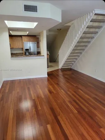 a view of a living room and wooden floor