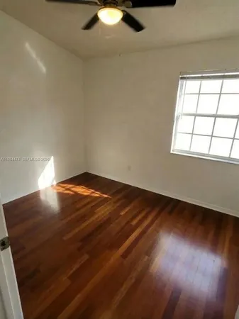 en empty room with wooden floor