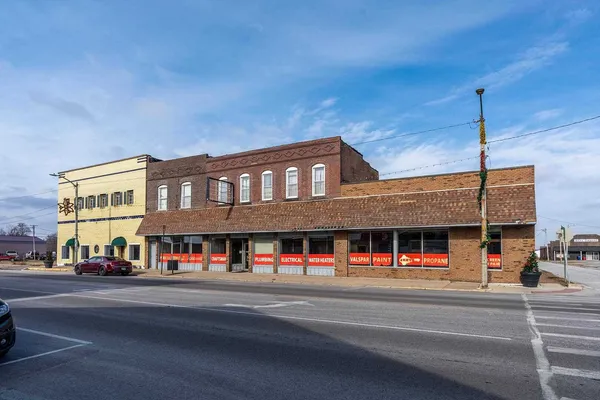a view of building with street view and car parked