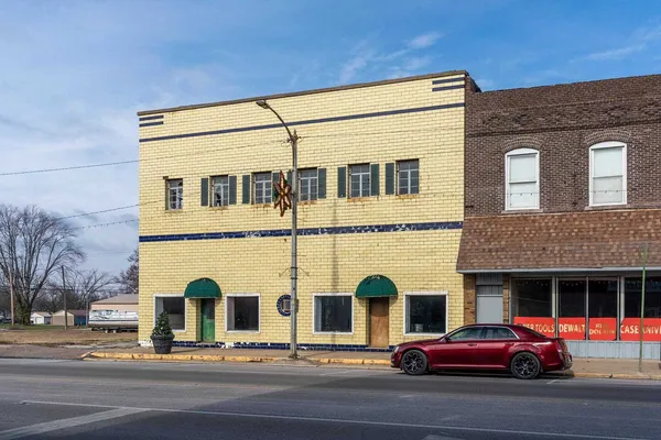 a view of a building with car parked