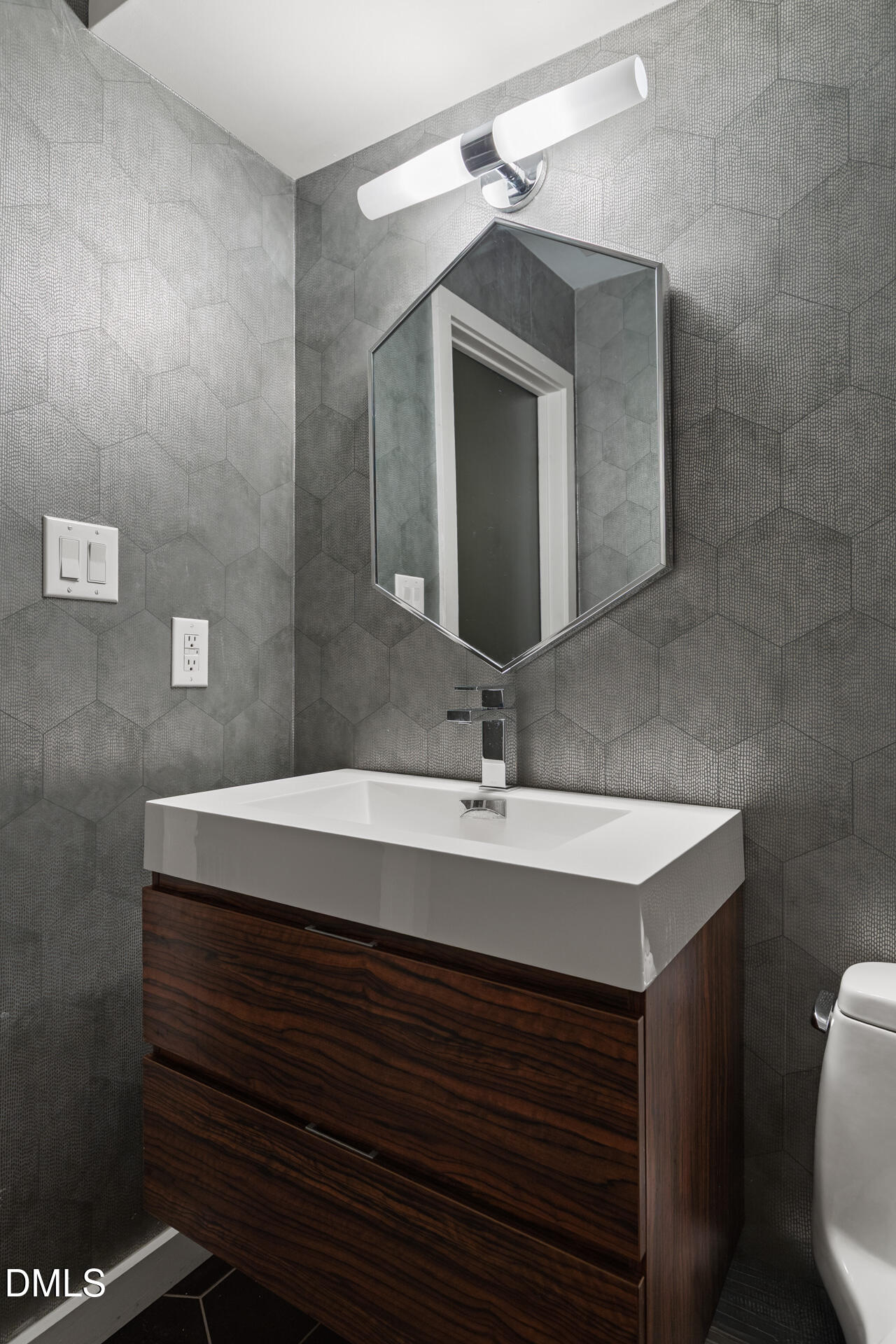 5208 Saddle Court Raleigh, NC 27609 - Photo 34 of 43 a bathroom with a sink a mirror and vanity