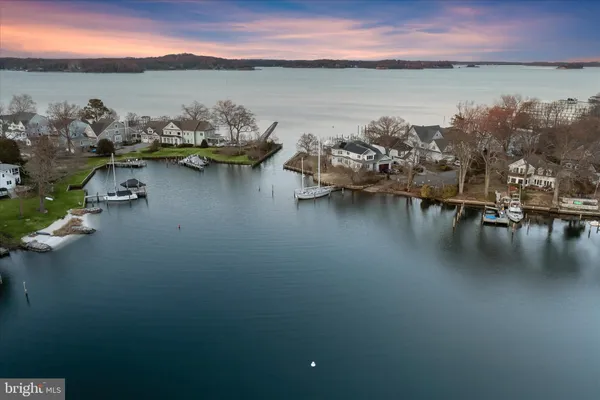 a view of a lake with lawn chairs