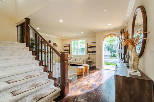 a view of entryway and hall with wooden floor