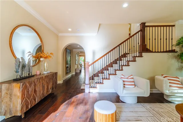 a view of entryway and hall with wooden floor
