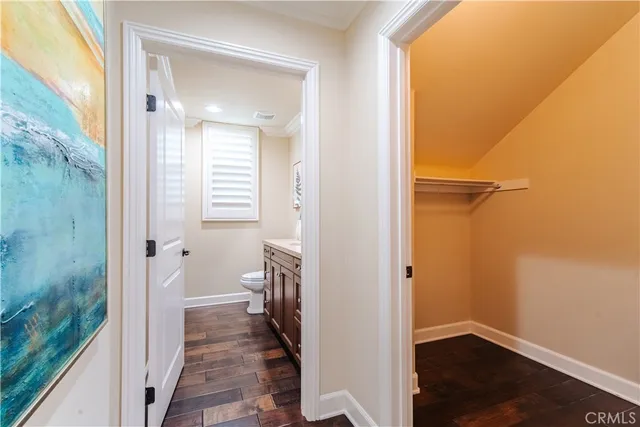 a bathroom with a granite countertop sink a toilet and a mirror