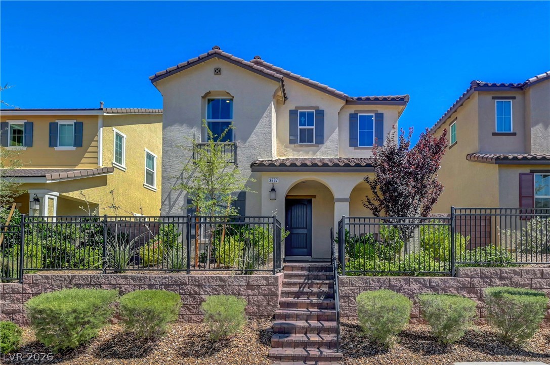 Mediterranean / spanish-style house with stucco siding and a tile roof