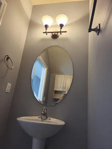 an empty room with windows and fireplace