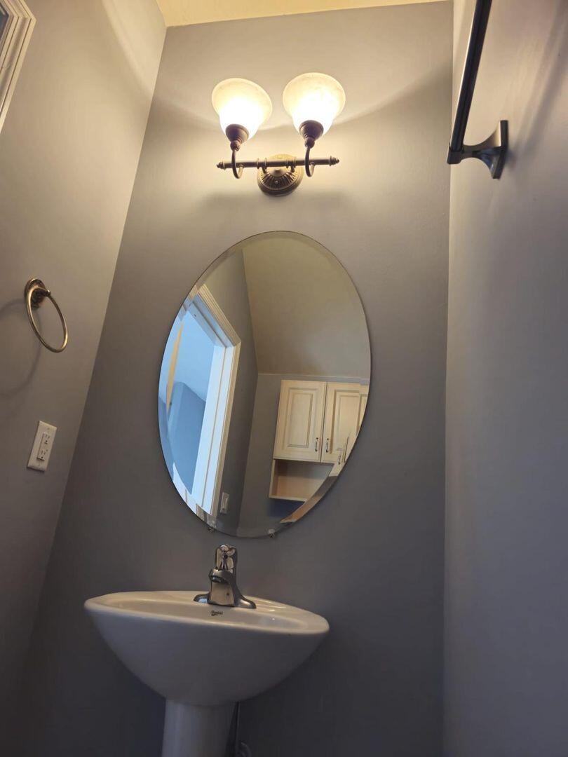 3123 Grandiflora Drive Greenacres, FL 33467 - Photo 14 of 49 a bathroom with a sink and a mirror