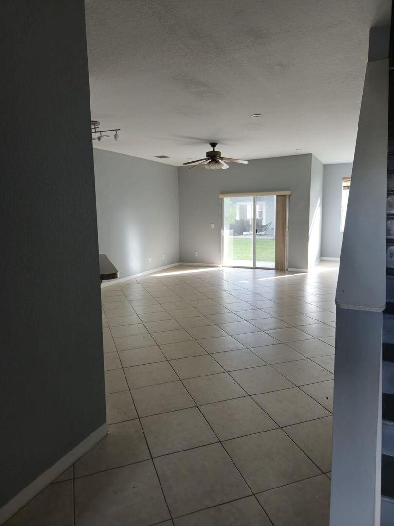 3123 Grandiflora Drive Greenacres, FL 33467 - Photo 16 of 49 an empty room with windows and fireplace