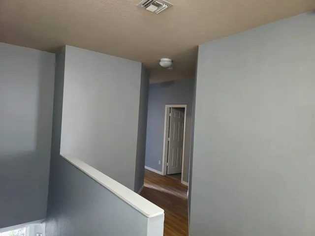 an empty room with wooden floor